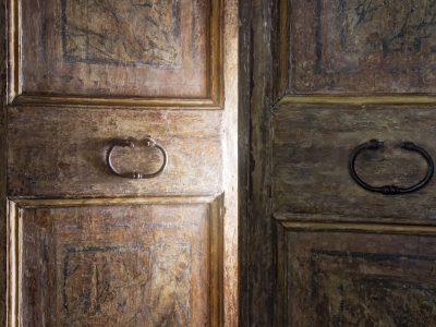 Old wooden door opening with light shining through